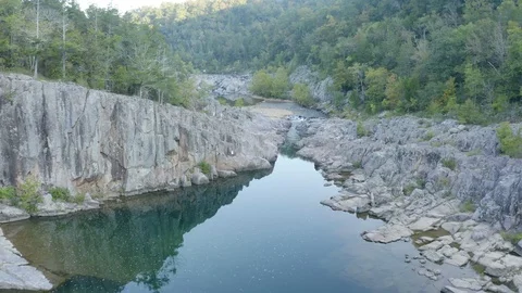 Reverse flight over a river running through rocks Stock Footage 111581977