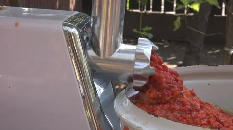Reverse flow effect tomatoes chopped from mincing machine, food equipment tools Stock Footage 41752530