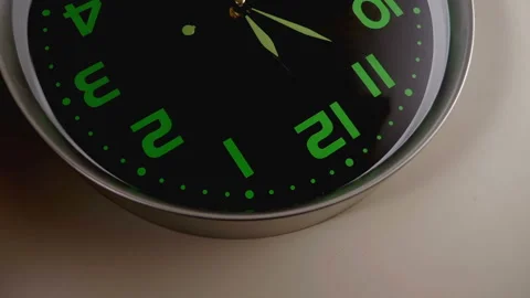  reverse image of a wall clock with with the clock hands spinning Stock Footage 130438900