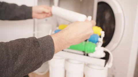 Reverse Osmosis System with White Filter Element Pouring Water into a Stock Footage 296571588