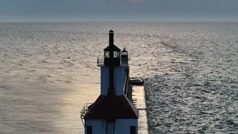 Reverse reveal drone view of the St. Joseph North Pierhead lighthouse on Lake Stock Footage 346015690