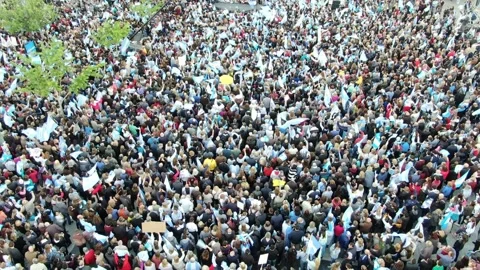 Reverse shot and distance shot over a crowd waving Argentinian flags. Stock Footage 168711571