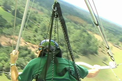Reverse Shot of Solo Hang Glider Aerial POV Flying Flight Stock Footage 141471
