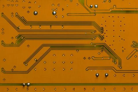 The reverse side of the electronic circuit board is yellow-brown. Stock Photos