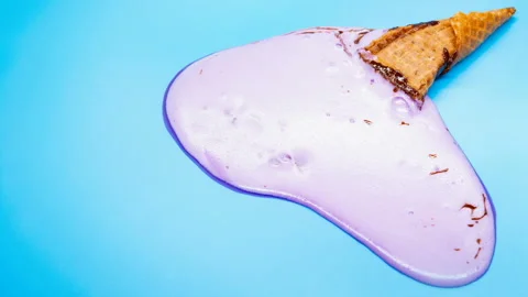 Reverse of side view lilac ice cream cone melting timelapse on blue Stock Footage 108623034