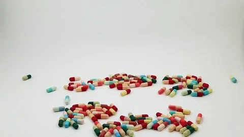 Reverse Slow Pills and Capsules Medicine  is falling down the ground Stock Footage 77895358