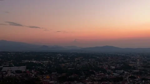 Reverse sunrise timelapse dolly out over Cuernavaca, Mexico Video stock 328263494