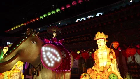 Reverse Tilt and Pan Shot of Glowing Buddhist Figures at Jeonggwangsa Temple Stock Footage 276659488