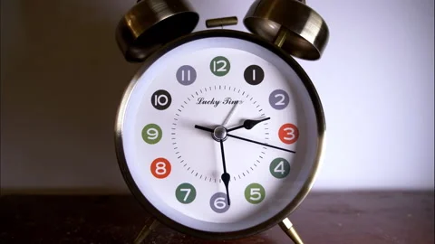 Reverse Time-Lapse of Chrome Alarm Clock with Colorful Hours Stock Footage 336674070