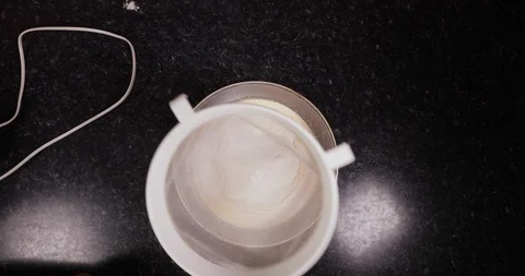 Reverse Time Lapse Of Lady Sieving Flour Into Batter To Prepare For Baking Stock Footage 109201851