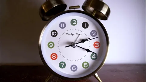 Reverse time ticking on old fashioned alarm clock with bells Stock Footage 336644402