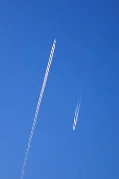 Reverse track of planes in the blue sky Stock Photos
