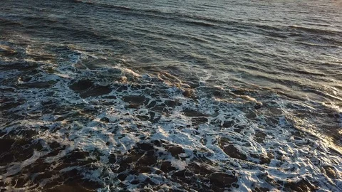 Reverse Tracking over California Waves and Rocky Beach Stock Footage 108567348