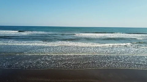 Reverse tracking shot of water's edge Stock Footage 82514970