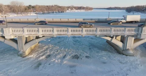 Reverse From Traffic On Ferry Street Bridge In Winter Champlin Minnesota - Drone Stock Footage 228894653