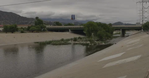 Reverse Wide Shot from Los Angeles River Walking Path with Bridge and Stock Footage 333649614