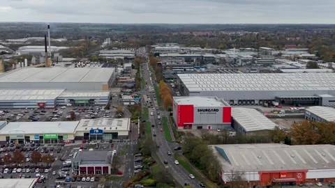 Reversing drone shot over Temple Mills Retail Park in Harlow, Essex, showing Stock Footage 321347804