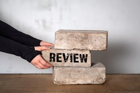 Review. Abstract business concept. Stack of white bricks on a wooden table Stock Photos