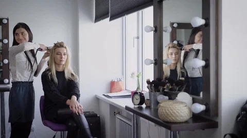 Review of beauty shop. Three models in beauty shop. Girls prepare for Stock Footage