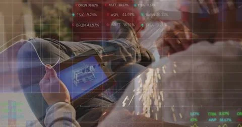 Reviewing 3D blueprint on tablet while colleague grinding metal with angle Stock Photos