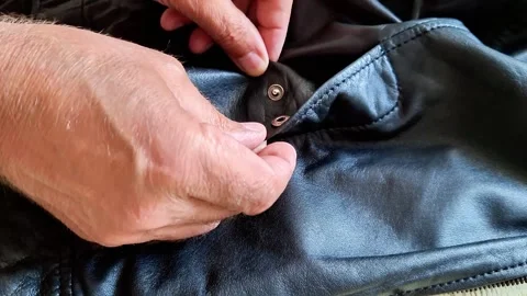 Reviewing Black Leather Jacket Pocket Close Up Indoors 스톡 동영상 343215920