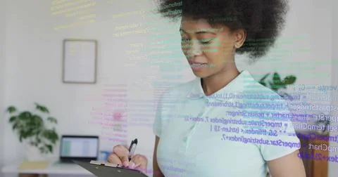Reviewing clipboard and code overlay, woman working in home office in light Stock Photos