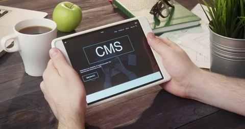 Reviewing CMS info using digital tablet at desk Stock Footage 80738935