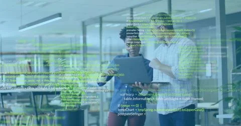 Reviewing code, professionals viewing laptop with green code overlay in office 스톡 사진