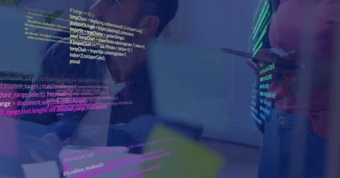 Reviewing code, three-person team leaning near glass display, presenter in pink Stock Photos