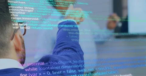 Reviewing code, two engineers collaborating on monitor in meeting room, with  Stock Photos