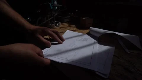 Reviewing Construction Plans in a Workshop Stock Footage 293541611