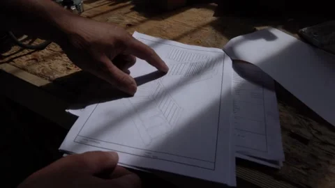 Reviewing Construction Plans in a Workshop Vídeos de archivo 293541729