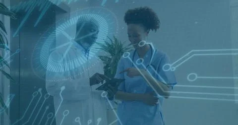 Reviewing data in clinic, Dr lab coat, nurse in scrubs with stethoscope holding Stock Photos