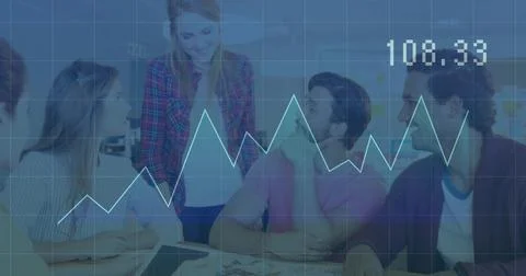 Reviewing data, five professionals collaborating at table in office, with lap Stock Photos