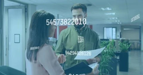 Reviewing data overlay and documents, office professionals in open-plan office Foto stock