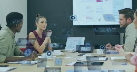Reviewing four professionals exploring 3D overlays in meeting room, with lapt Stock Photos