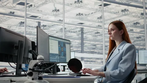 Reviewing microchip production operations, PC software and man with woman Stock Footage 335878055