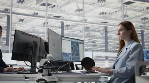 Reviewing microchip production operations, PC software and man with woman Stock Photos