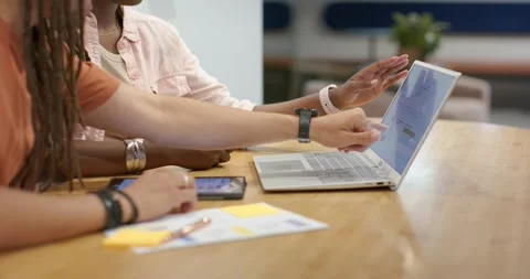 On reviewing notes, hands are leaning, pointing and tapping laptop and phone, Stock Footage 337400212