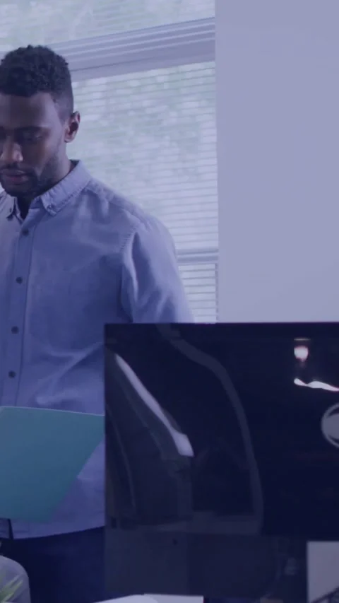 Reviewing office worker checking teal folder at desk in light blue shirt, Stock Footage 331050416