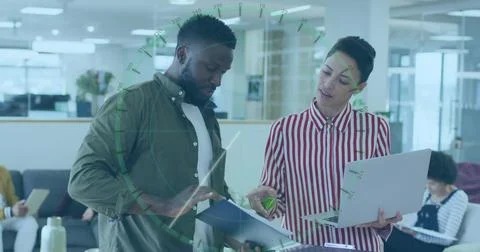 Reviewing professionals pointing at open document folder in modern office, with Stock Photos