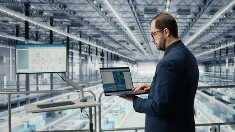 Reviewing schematics, laptop and engineer man in semiconductors smart factory Stock Footage 333379511