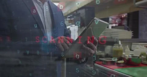 Reviewing tablet data manager standing behind service counter in cafeteria with Stock Photos
