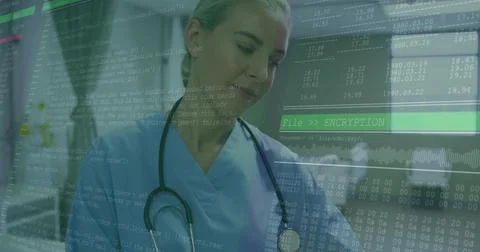 Reviewing translucent code overlay, nurse wearing blue scrubs with stethoscop 写真素材