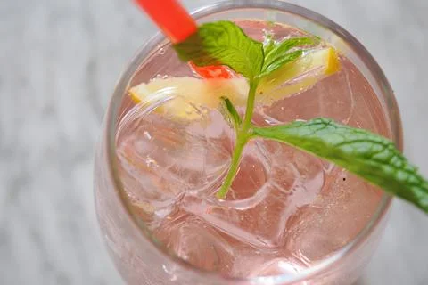A revitalizing drink featuring mint and lemon beautifully presented on a table Stock Photos