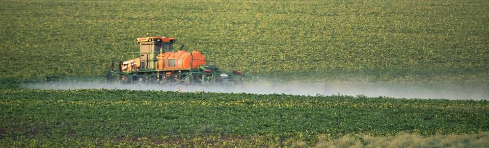 Revitalizing the Fields: A Tractor Sprayer at Work Stock Photos