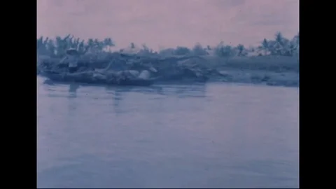 Revolutionary Development team pass native boats along narrow canal - 1969 Video stock 96143240