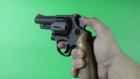 Revolver In male Hand. Pulls the trigger on the green Chroma key Stock Footage 150593449