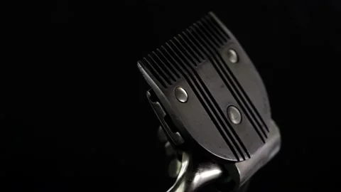Revolves metal vintage barber tool old manual clipper. on black background. Edge Stock-Footage 142135716