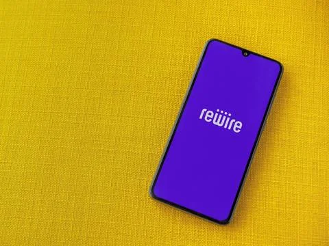 Rewire app launch screen on smartphone on yellow fabric background Stock Photos